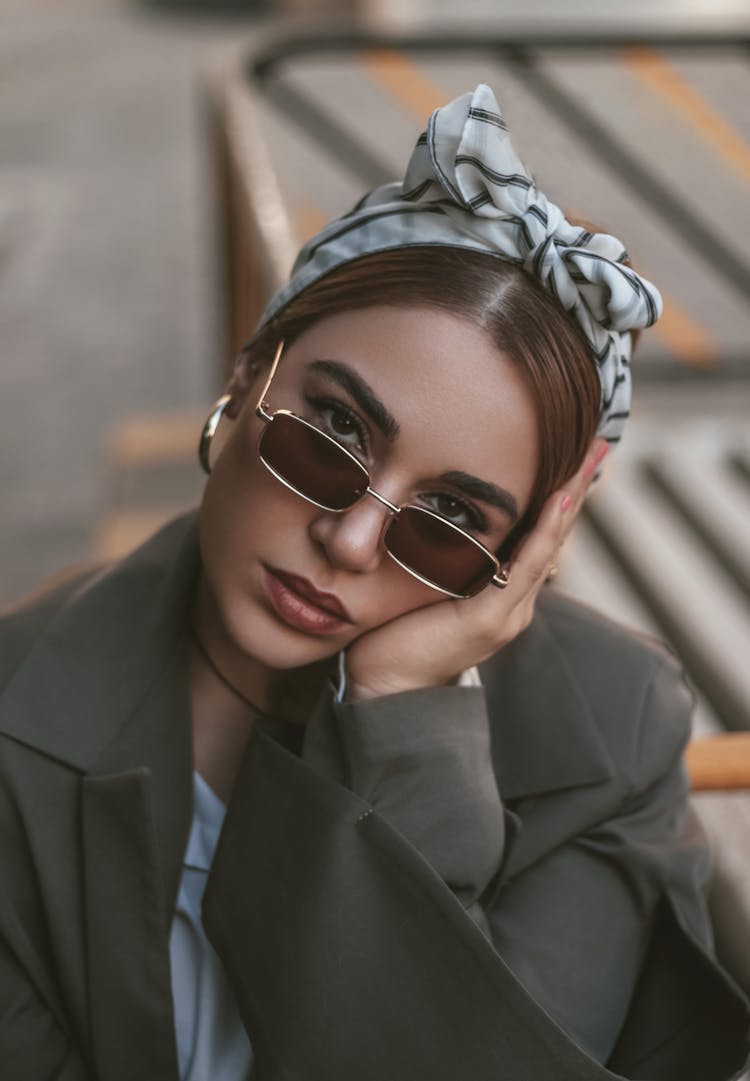 A Woman With Headscarf Wearing Sunglasses Resting Her Hand On Hand