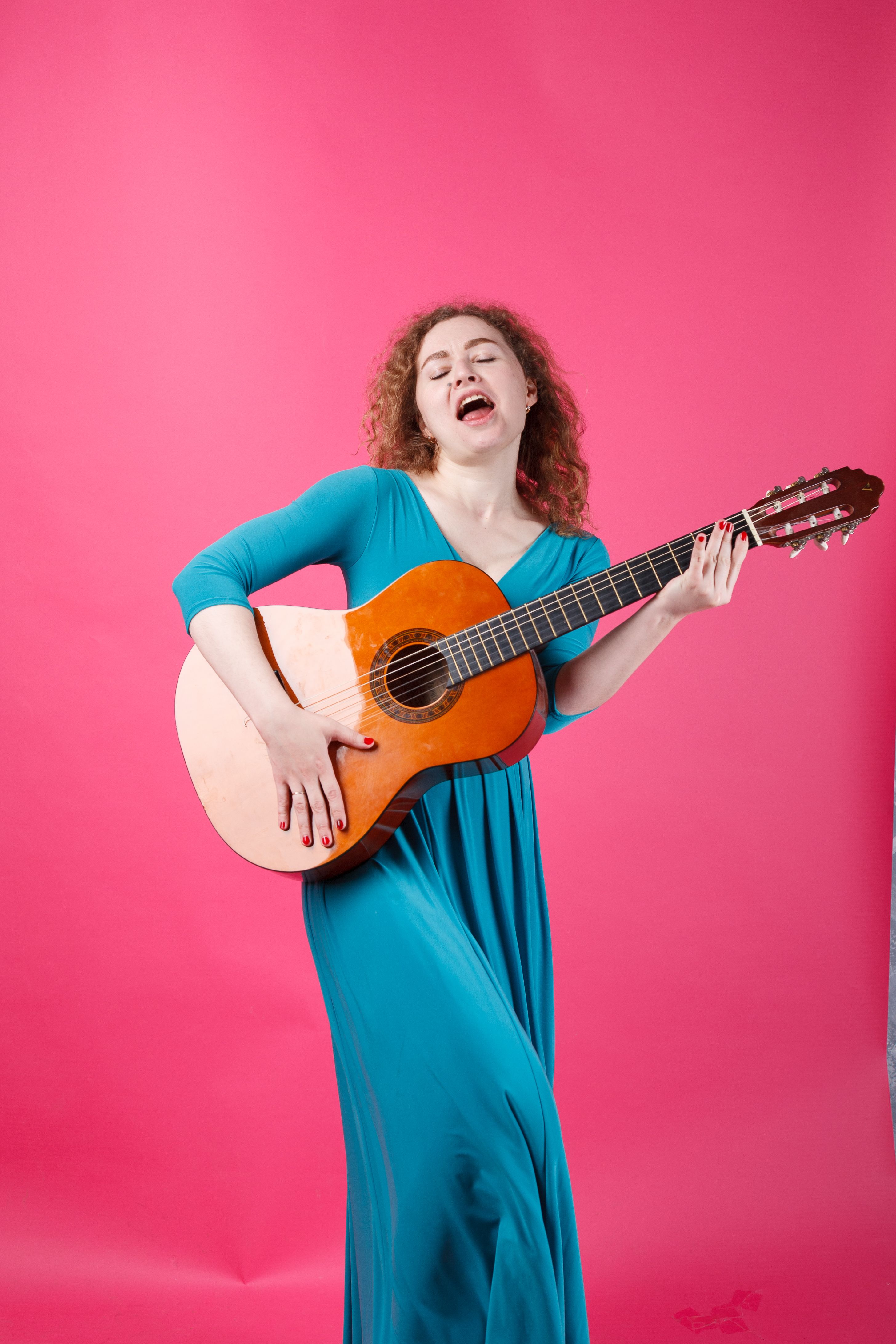 lady in a blue dress acoustic A Woman Holding an Acoustic Guitar · Free Stock Photo