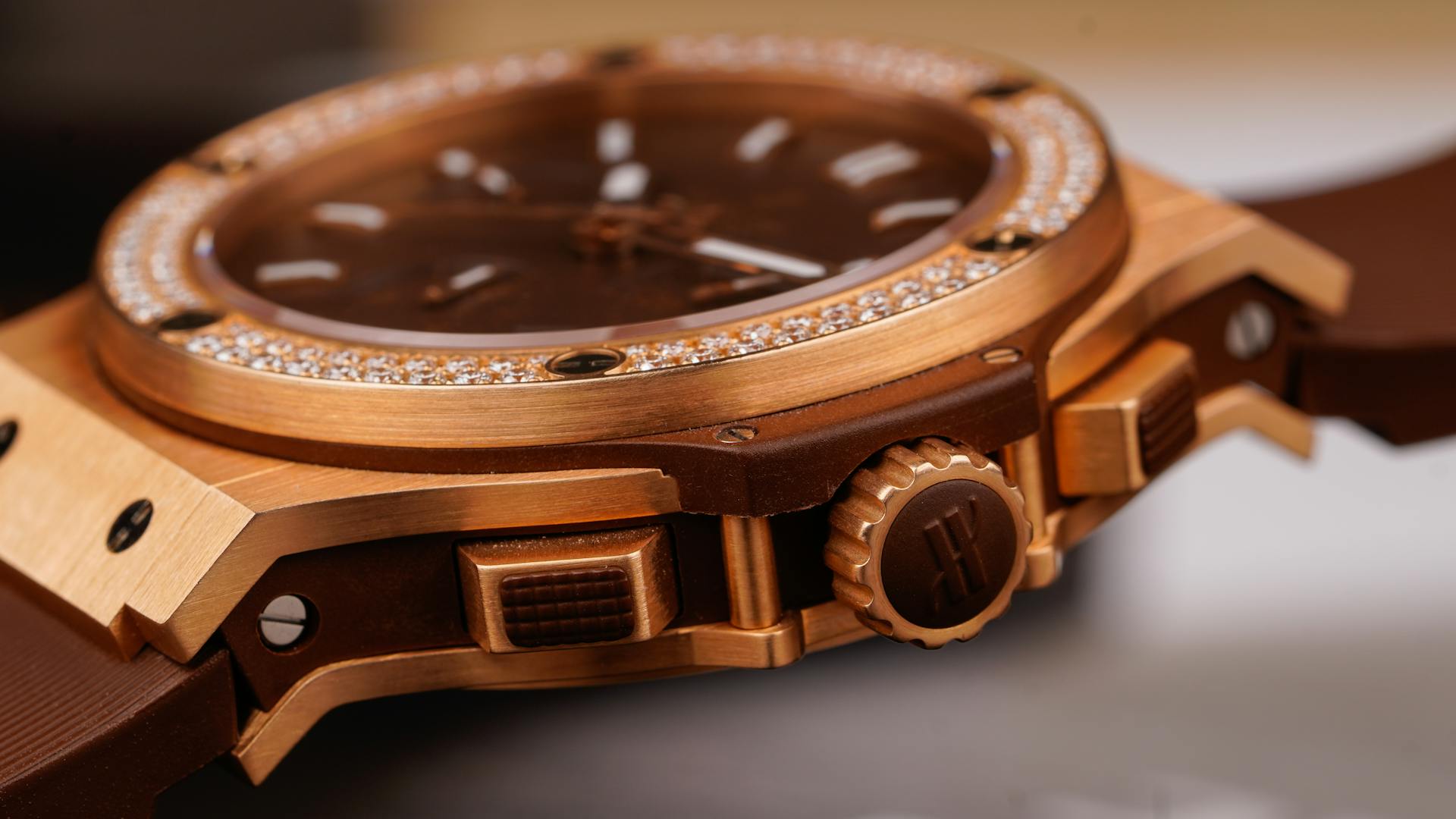 Detailed close-up of a luxury gold watch encrusted with diamonds and precision mechanics.