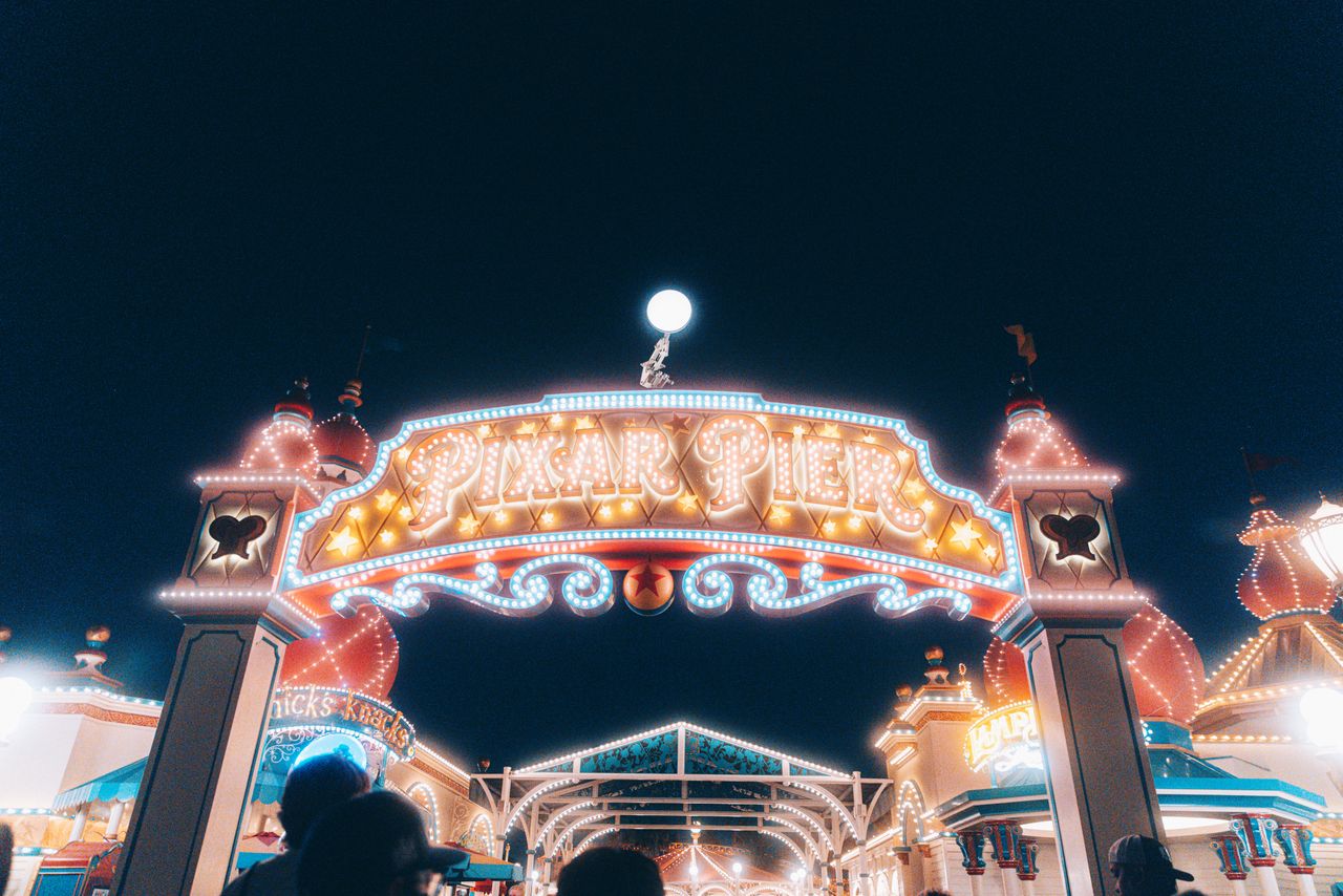 brightly lit entrance to pixar pier at night showcasing vivid carnival