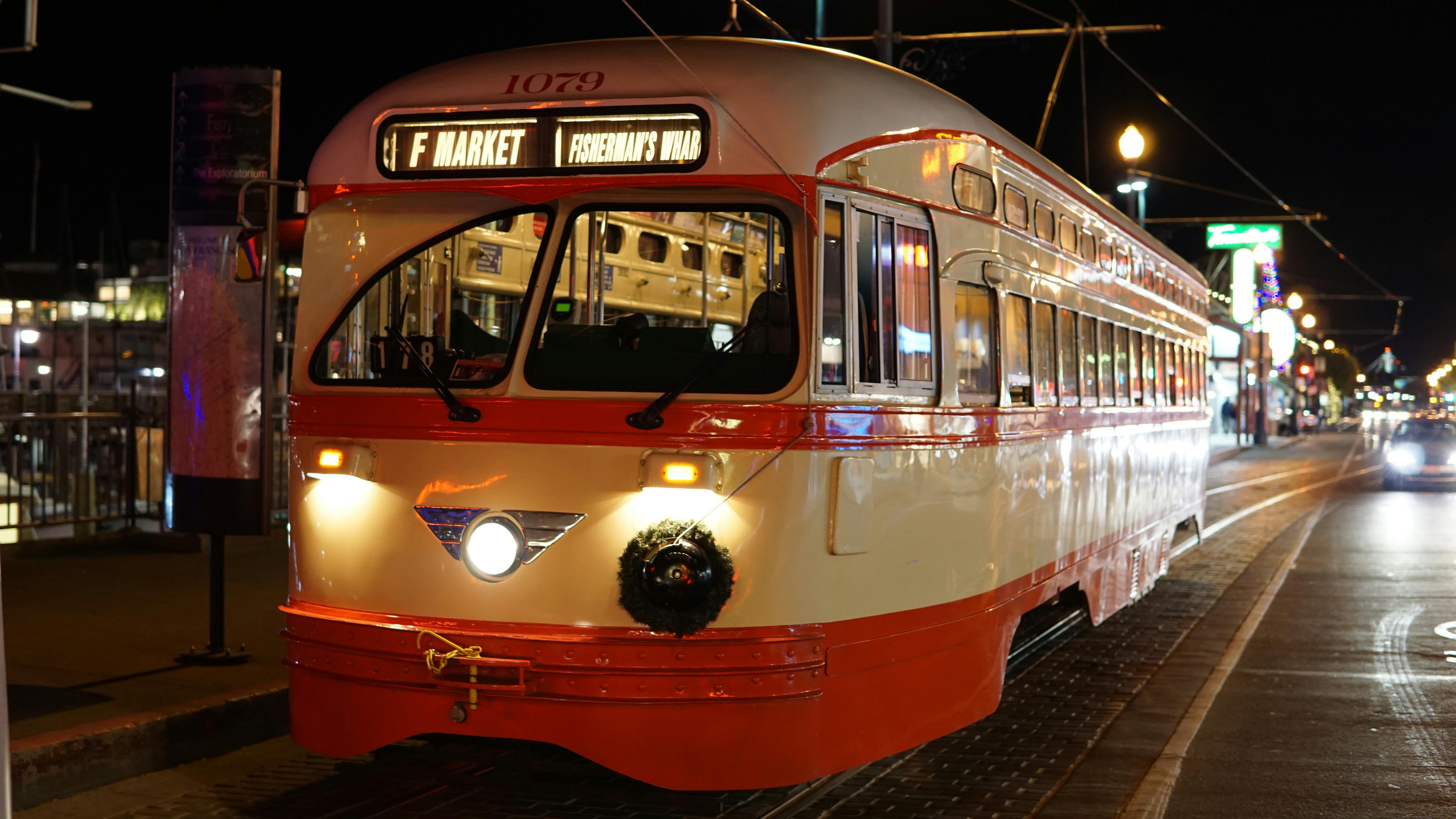 Free Vintage tram at Fisherman's Wharf, San Francisco illuminated at night on city streets. Stock Photo