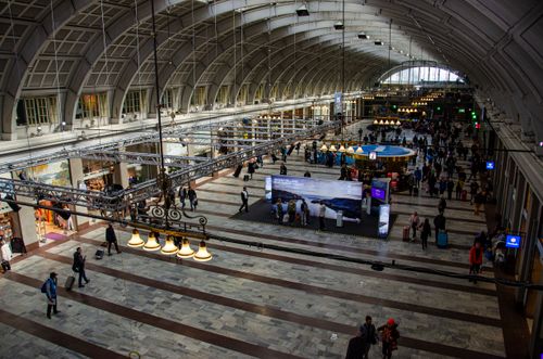 Free Overhead view of commuters moving through the spacious and bustling Stockholm train station. Stock Photo