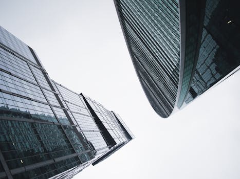 Low angle view of modern skyscrapers reaching into the sky, showcasing urban architecture.