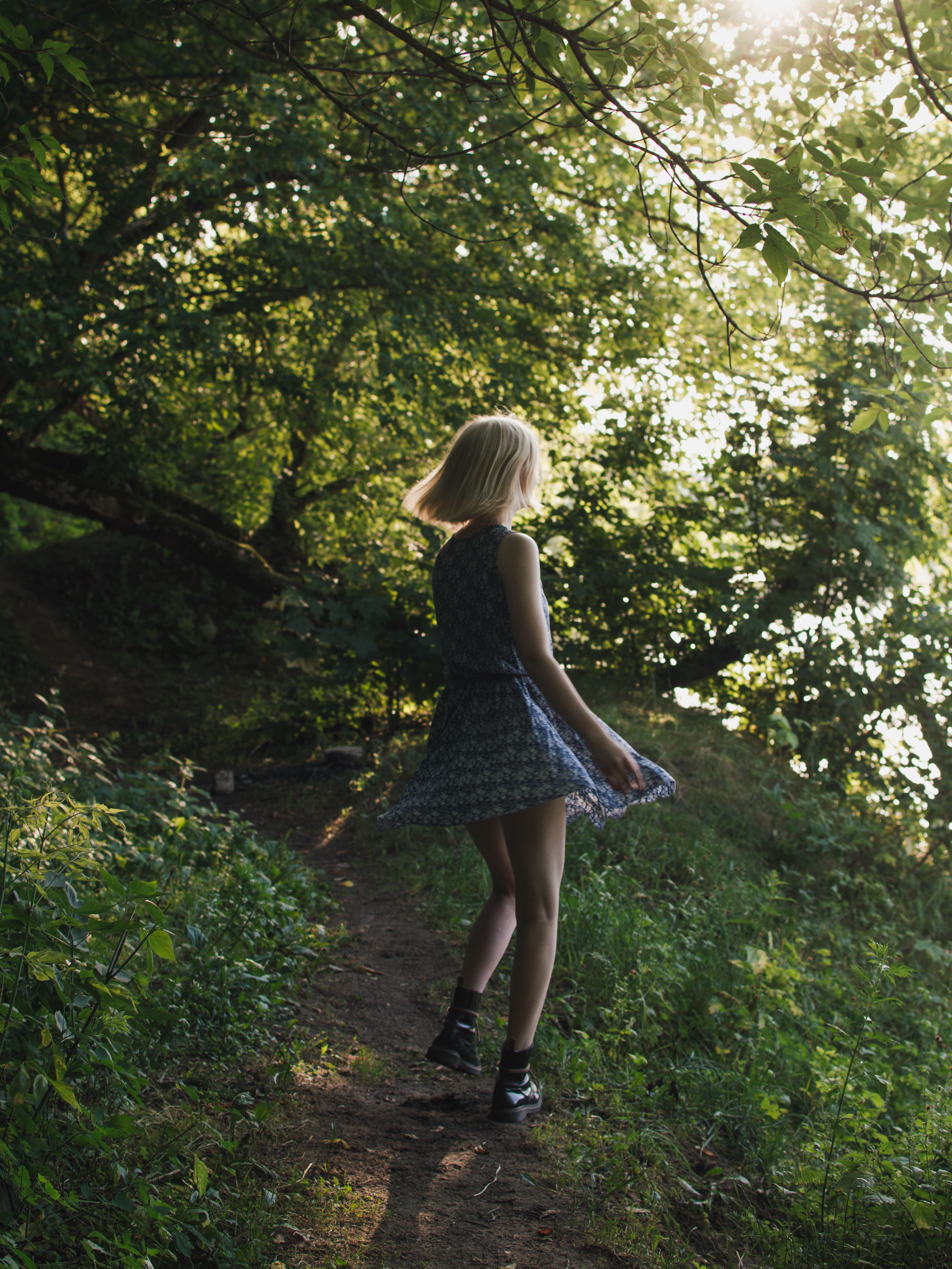 Woman in Blue Dress Standing on A Forest · Free Stock Photo