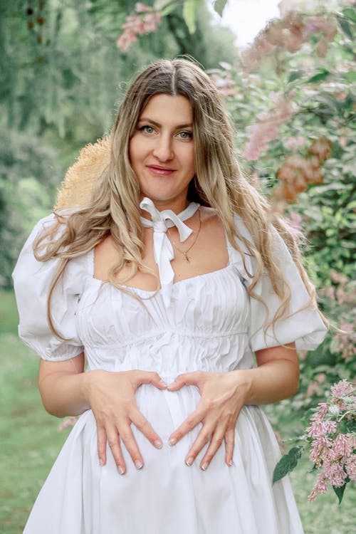 Free Pregnant Woman in White Dress Stock Photo