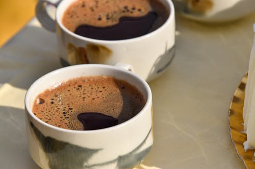 Black Coffee with Bubbles in White Cups in Close-up Photography