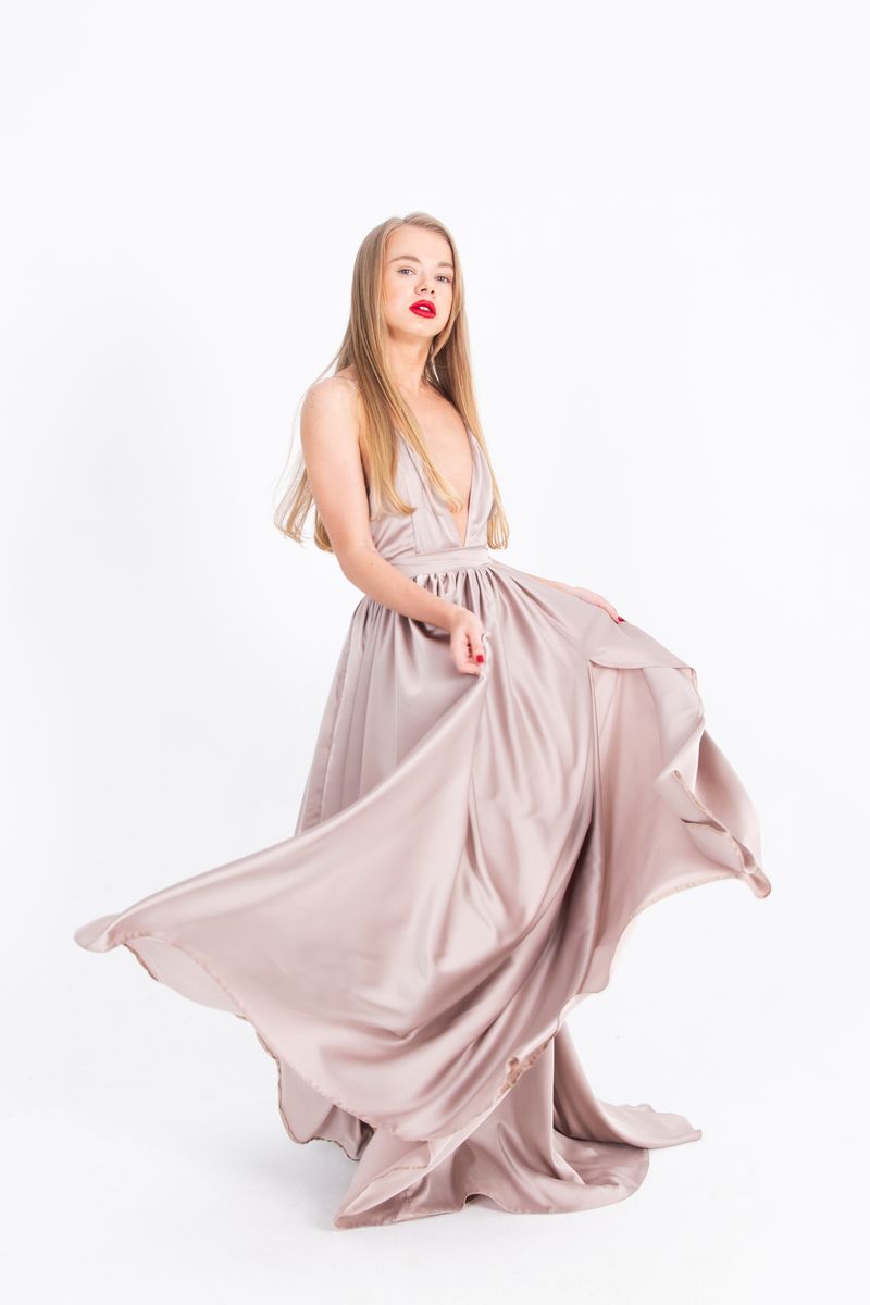 Woman in elegant draped dress, sophisticated date night outfit