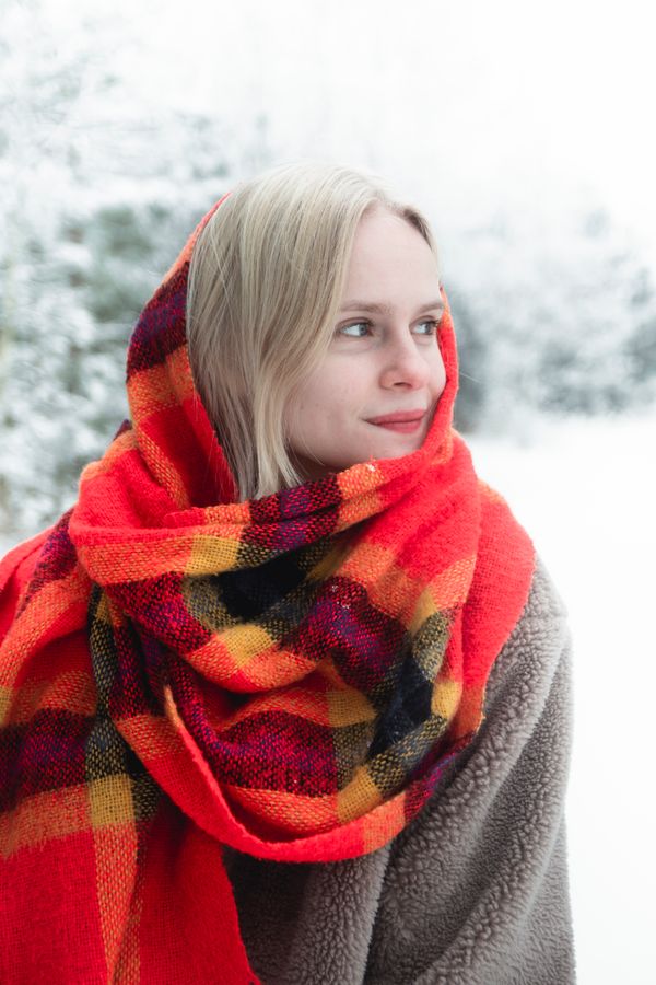 Woman wearing a blanket scarf with a basic coat