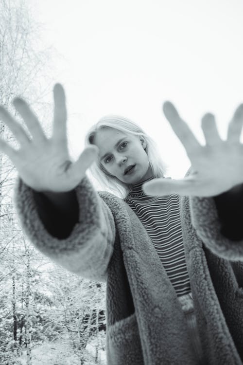 Black and White Photo of a Woman Reaching Out