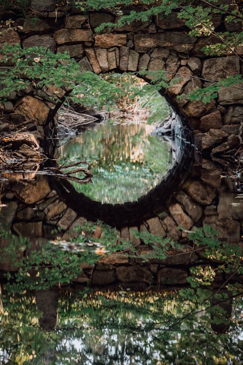 Small Old Arch Bridge Reflecting in the Water