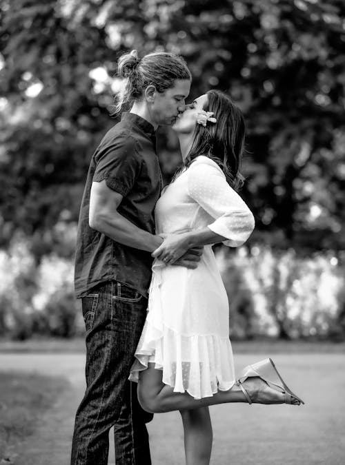 Grayscale Photo of a Couple Kissing
