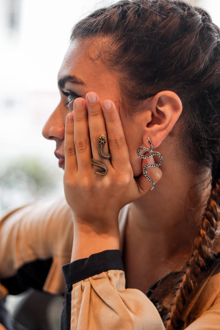 Woman Wearing Silver Snake Ring And Snake Earring