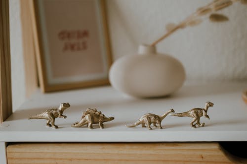 Dinosaur Toys on a White Wooden Table