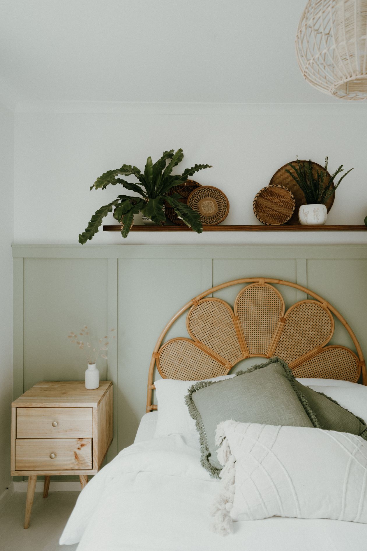 Bed with layered pillows in muted colors
