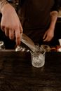 Person Putting Ice On a Glass