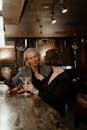 Man and Woman Sitting beside Bar Counter