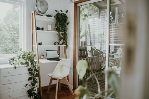 Free Minimalist home office with Scandinavian design, featuring greenery and natural light. Stock Photo