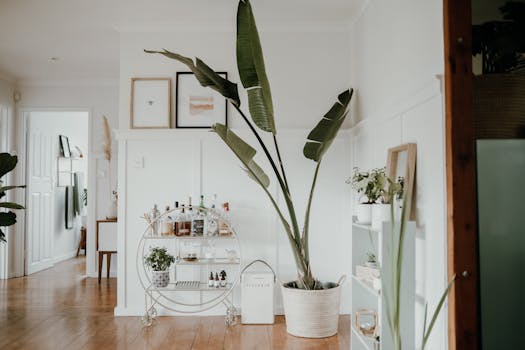 Cozy minimalist room featuring a stylish bar cart and lush plant for added elegance.