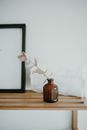 Brown Glass Bottle on Brown Wooden Table
