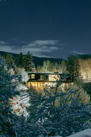 Lit cabin in the snow at night — photo by Isaac Garcia on Pexels