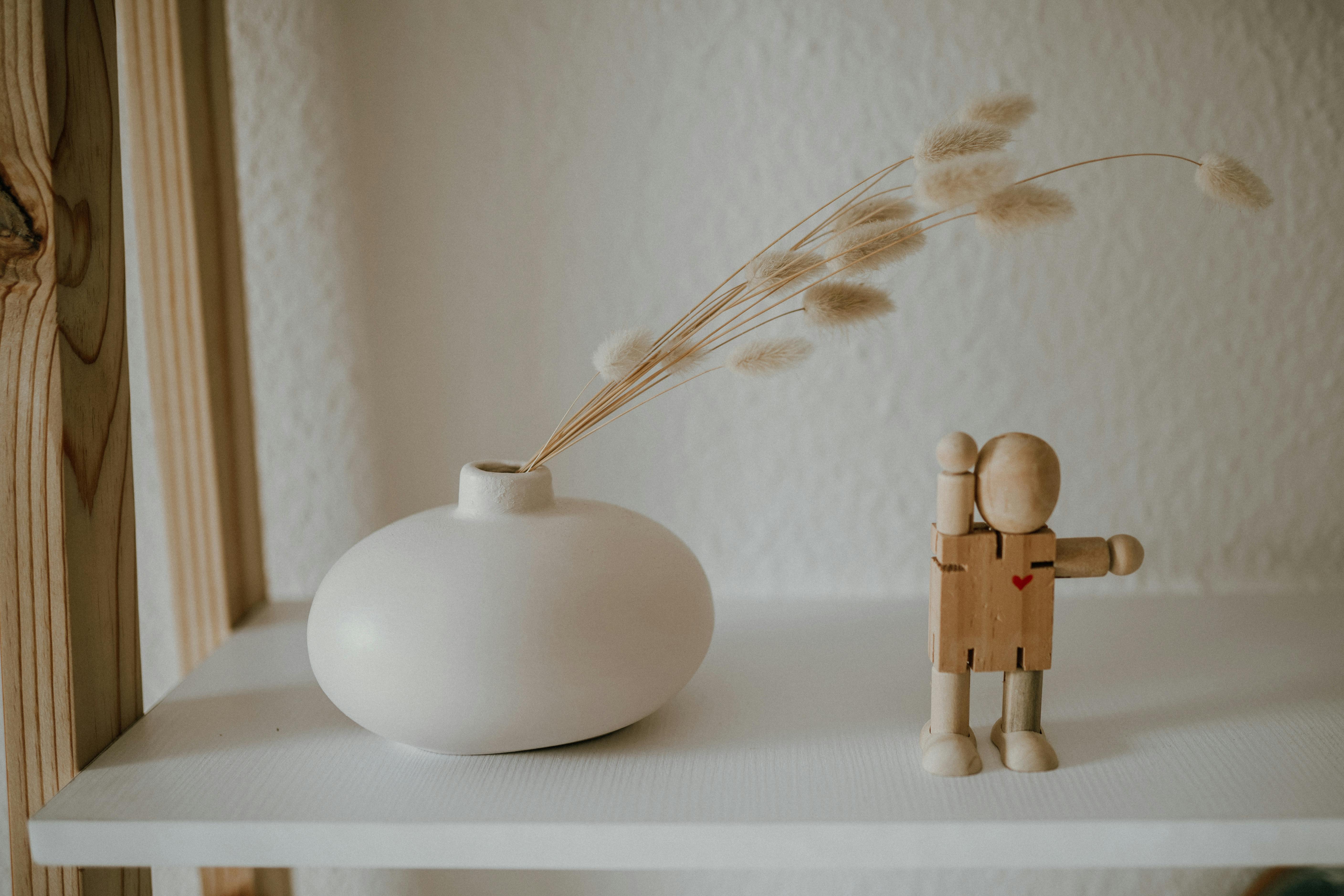 white ceramic vase with dried grass