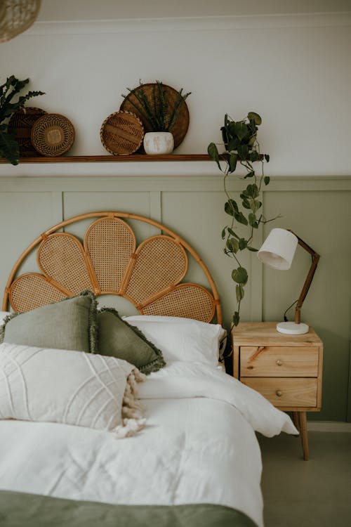 A Wooden Themed Bedroom with Floral Wooden Headboard