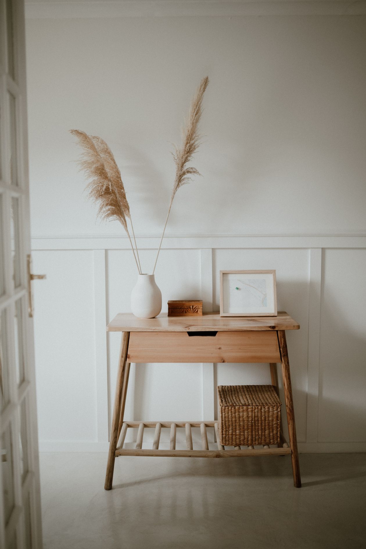 how to style a console table: a wooden console table styled with pampas grass