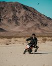 A Man Riding a Small Motorcycle on Dirt Road
