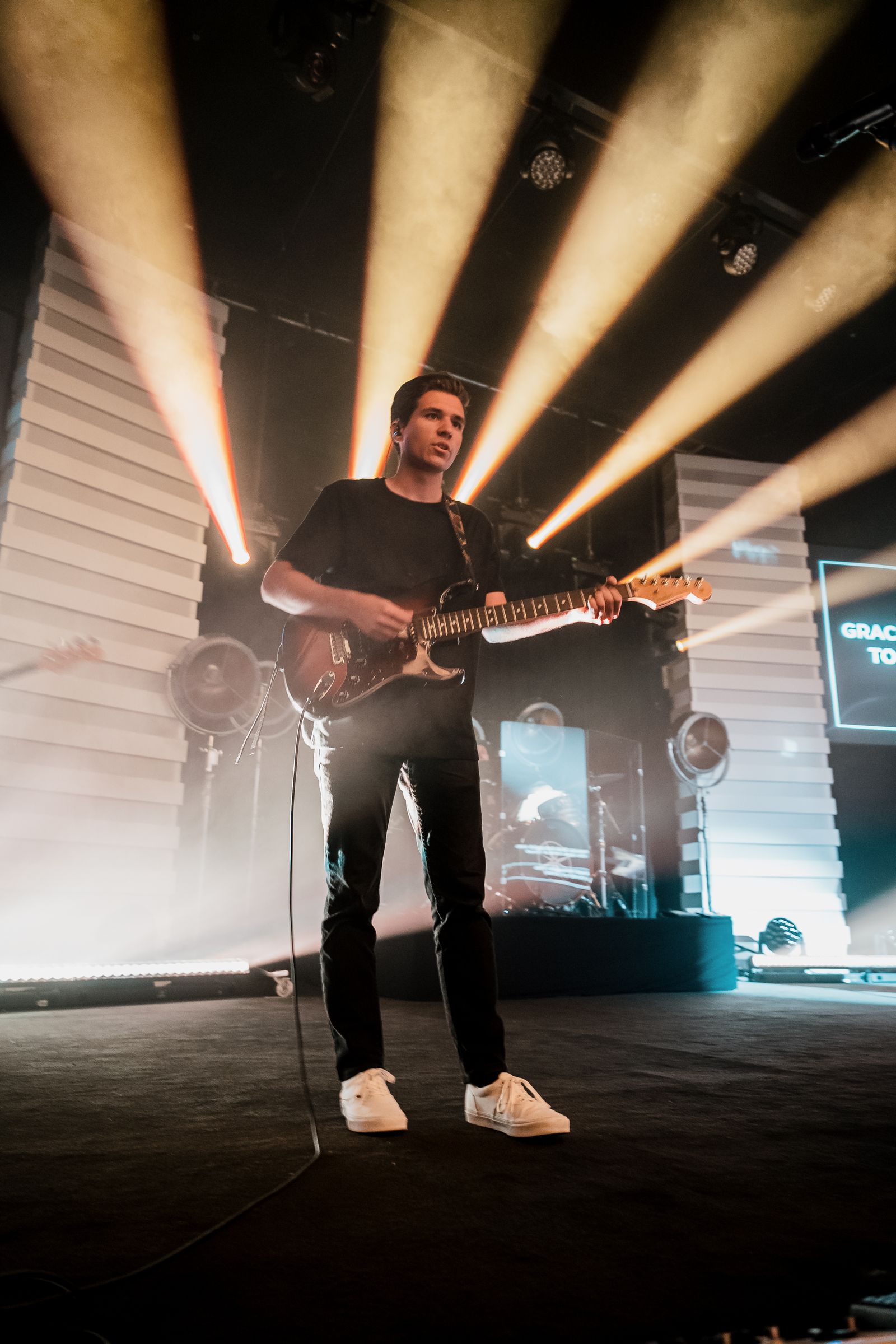 Guitarist playing under stage lights