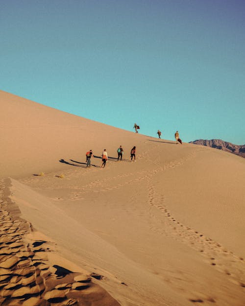 Free People Walking on Desert Stock Photo