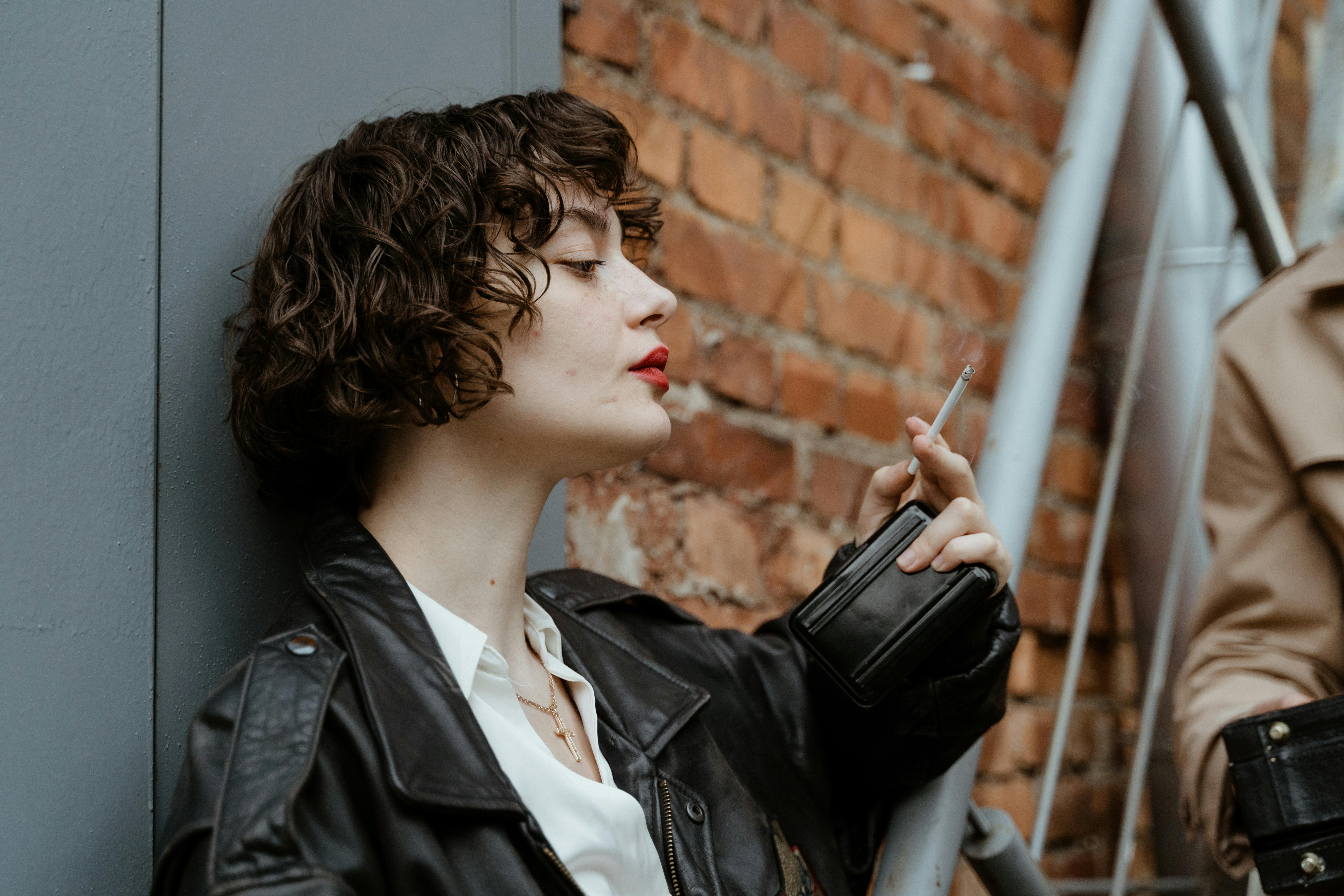 Woman in Black Leather Jacket Holding Metal Chain · Free Stock Photo