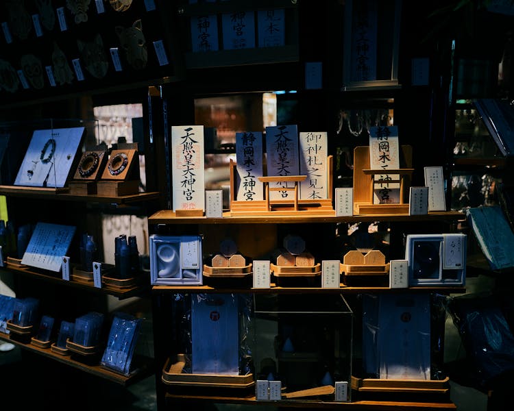 Assorted Merchandise On Wooden Shelves With Leaflets