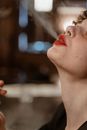 Person with Red Lips Puffing Out Smoke