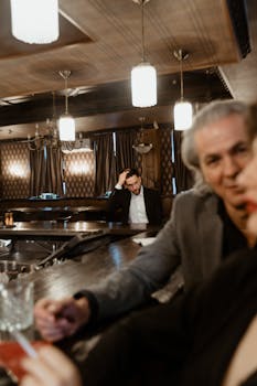 A moody bar setting with people engaged and deep in thought, creating a cinematic atmosphere.