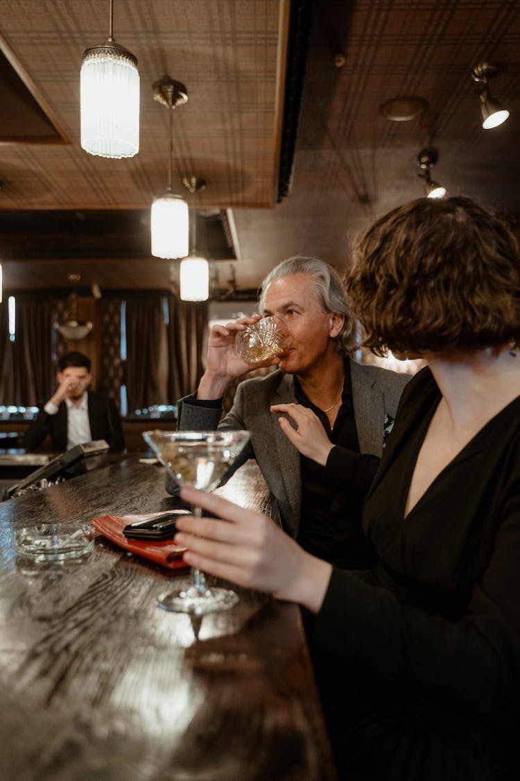 Man And Woman Drinking In A Bar