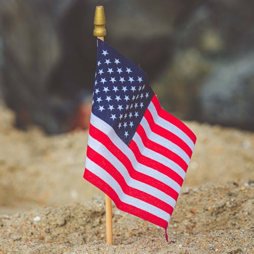 United States Flag on Brown Sand