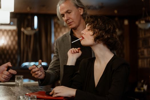 A Woman in Black Coat Smoking Cigarette