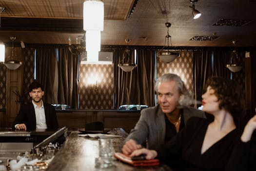 Sophisticated bar interior hosting people engaged in conversation, capturing a vibrant social atmosphere.