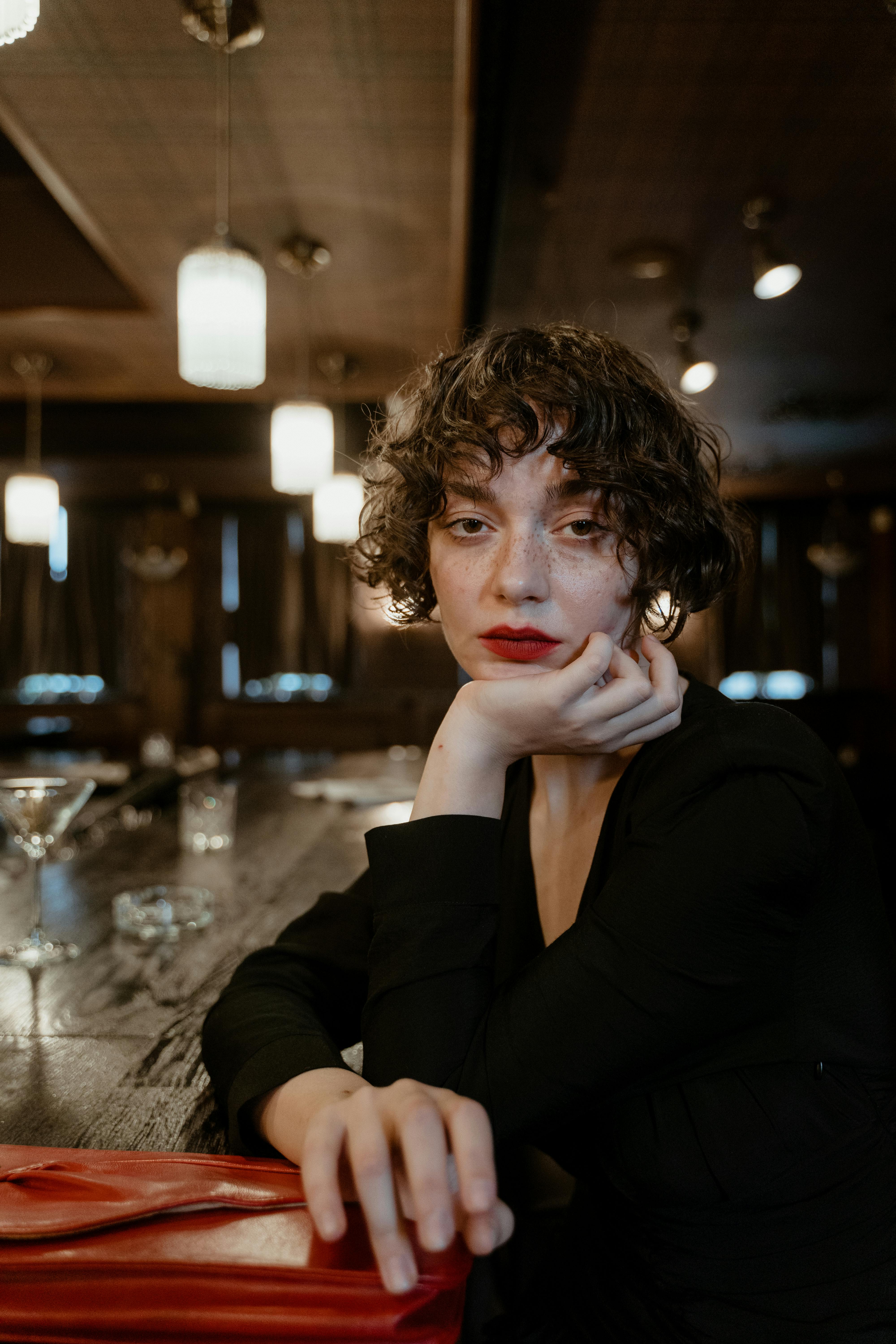 a woman in black blazer posing at the camera