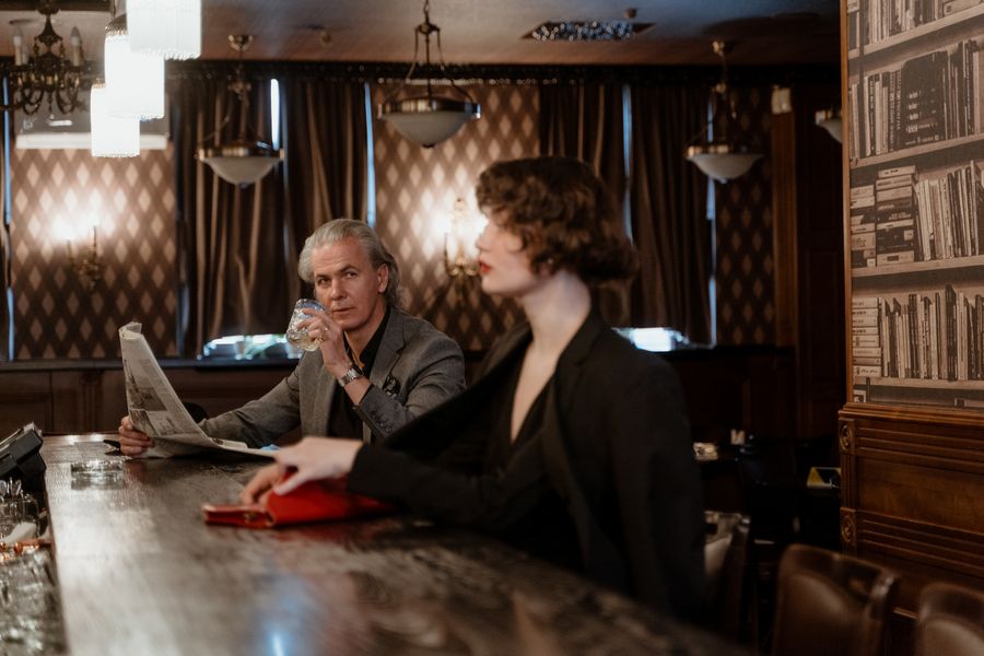 Sophisticated adult woman seated with a mature gentleman in a premium lounge