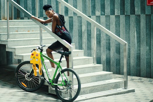 年轻女子在城市楼梯上骑自行车摆姿势，展现现代时尚