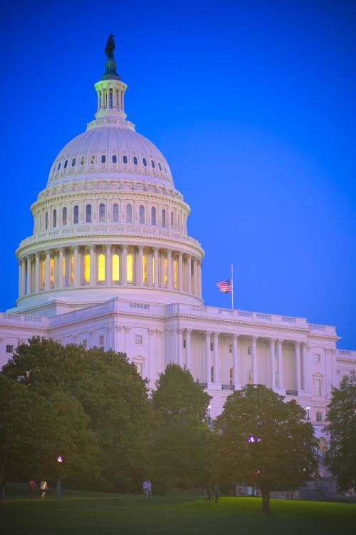 Free The iconic US Capitol in Washington DC with a vibrant twilight sky, showcasing classic neoclassical architecture. Stock Photo