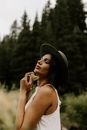 Woman in White Tank Top Wearing Black Fedora Hat