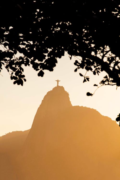 Free Silhouette of Christ the Redeemer during golden hour in Rio de Janeiro, Brazil. Stock Photo