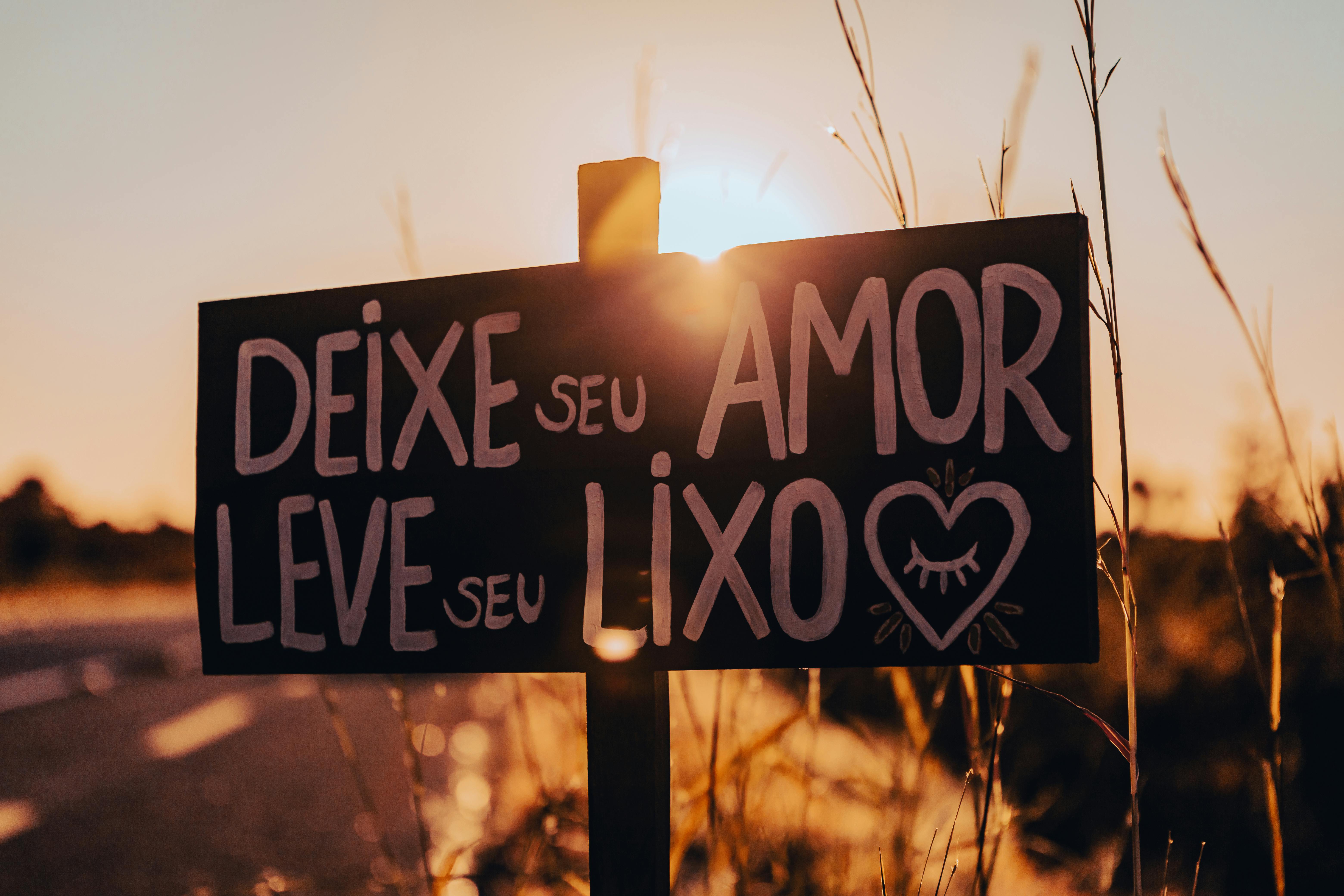 Close-up of a roadside sign with a positive message at sunset in Brazil.