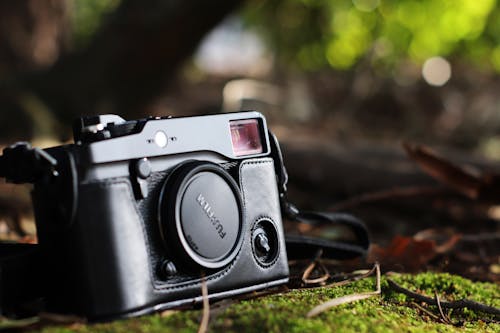 Selective Focus Photo of Black Fujifilm Camera on Ground