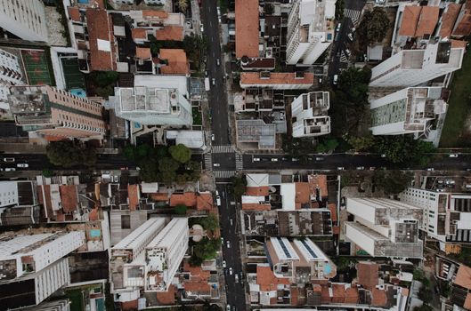 Drone view capturing urban high-rises and roads, showcasing metropolitan life.