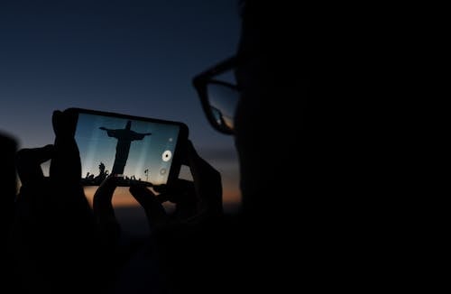 Person Taking Photo of a Statue 