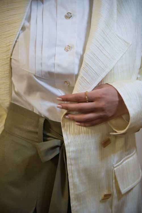 Free Close-up of stylish outfit with cream jacket and gold accessories in Tehran. Stock Photo