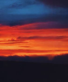 Stunning twilight colors paint the sky over Ithaca, NY, capturing a dramatic and serene moment.